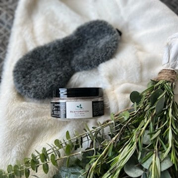 Restoration Salt Soak, white bath robe, furry grey eye mask, floral shower bundle for bath self-care